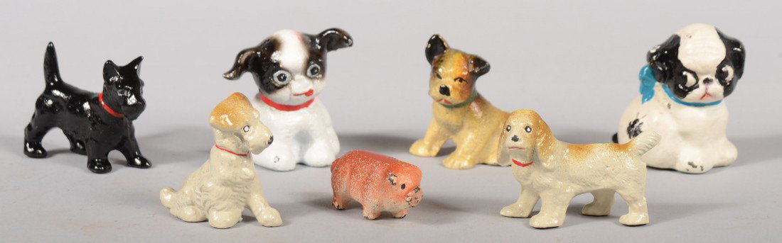 Six Miniature Hubley Painted Cast Iron Dogs and a : Six Miniature Hubley Painted Cast Iron Dogs and a Pig. Including: Two 'Pupo' dogs, three terriers, a spaniel and a pig. Average size: 1 1/2"l. Condition: Good with use wear.