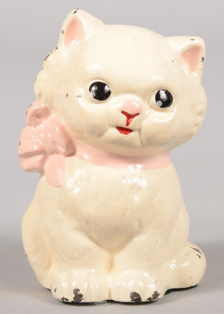 Hubley Kitty Kat Still Bank. White painted cast ir: Hubley Kitty Kat Still Bank. White painted cast iron with pink ribbon and nose. 5"h. Condition: Good with use wear.
