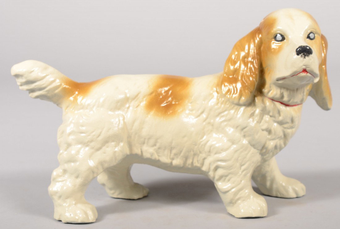 Cast Iron Spaniel Doorstop. Golden brown spots on : Cast Iron Spaniel Doorstop. Golden brown spots on a white coat. 7"h. X 11"l. Condition: Good.