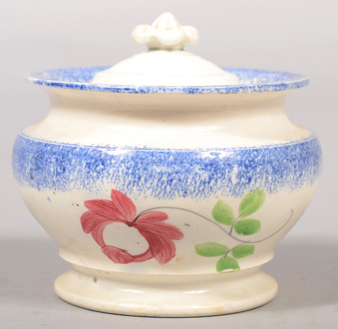 Spatterware Covered Sugar Bowl. Bulbous form with : Spatterware Covered Sugar Bowl. Bulbous form with flanged rim and raised molded foot. Blue spatter on lid and bowl rim and shoulder with a red Adams rose with green leaves. Unmarked. 4 1/2"h. X 5"dia.