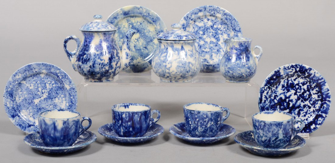 Blue Sponge Decorated Ironstone Child's Tea Servic: Blue Sponge Decorated Ironstone Child's Tea Service. Covered Teapot; 3 3/4"h.; covered sugar: 3 1/4"h.; creamer: 2 1/2"h.; four cups with saucers: 2 1/2"h. X 3 5/8"dia.; four plates: 4"dia. Unmarked. 