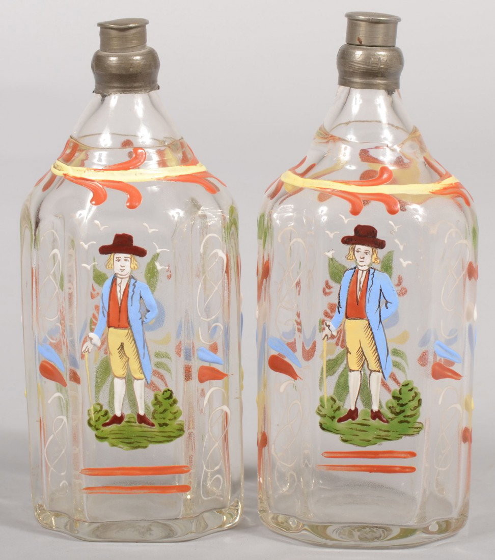 Pair of Stiegel style Cologne Decanters. Polychrom: Pair of Stiegel style Cologne Decanters. Polychrome enamel decorated mold blown glass bottles with pewter spouts and caps. Marked on bottoms: "Made in Austria." 5 3/4"h. Condition: Good.
