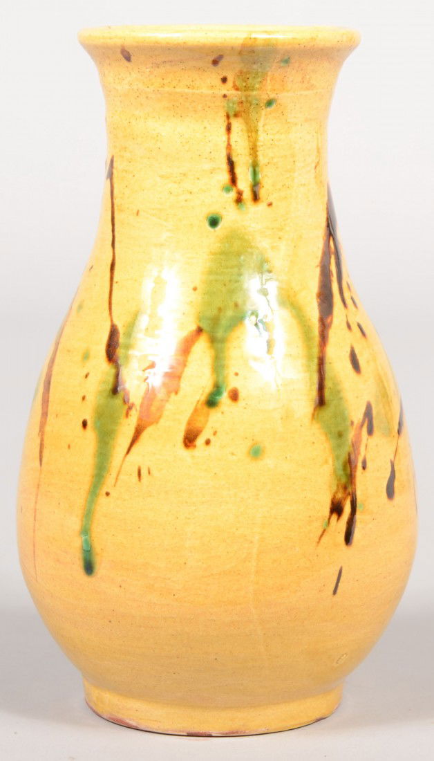Contemporary Redware Water Jar or Vase. Bulbous sh: Contemporary Redware Water Jar or Vase. Bulbous shape with foot, yellow slip ground inside and out with manganese and green freehand decoration. Marked on bottom: "S. C. 1997." 8"h. Condition: Good.