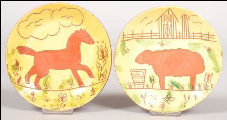 Two Contemporary Redware Plates. Both with yellow: Two Contemporary Redware Plates. Both with yellow slip ground with green splotches and incised animal decorations: a lamb in a barnyard and a horse in a meadow. Both marked: "Breininger Pottery, Robes