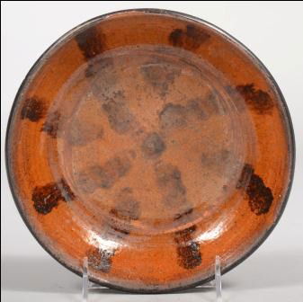 Manganese Decorated Redware Dish. Stripes radiate: Manganese Decorated Redware Dish. Stripes radiate from center to rim. 8"dia. Condition: Good, with use wear.
