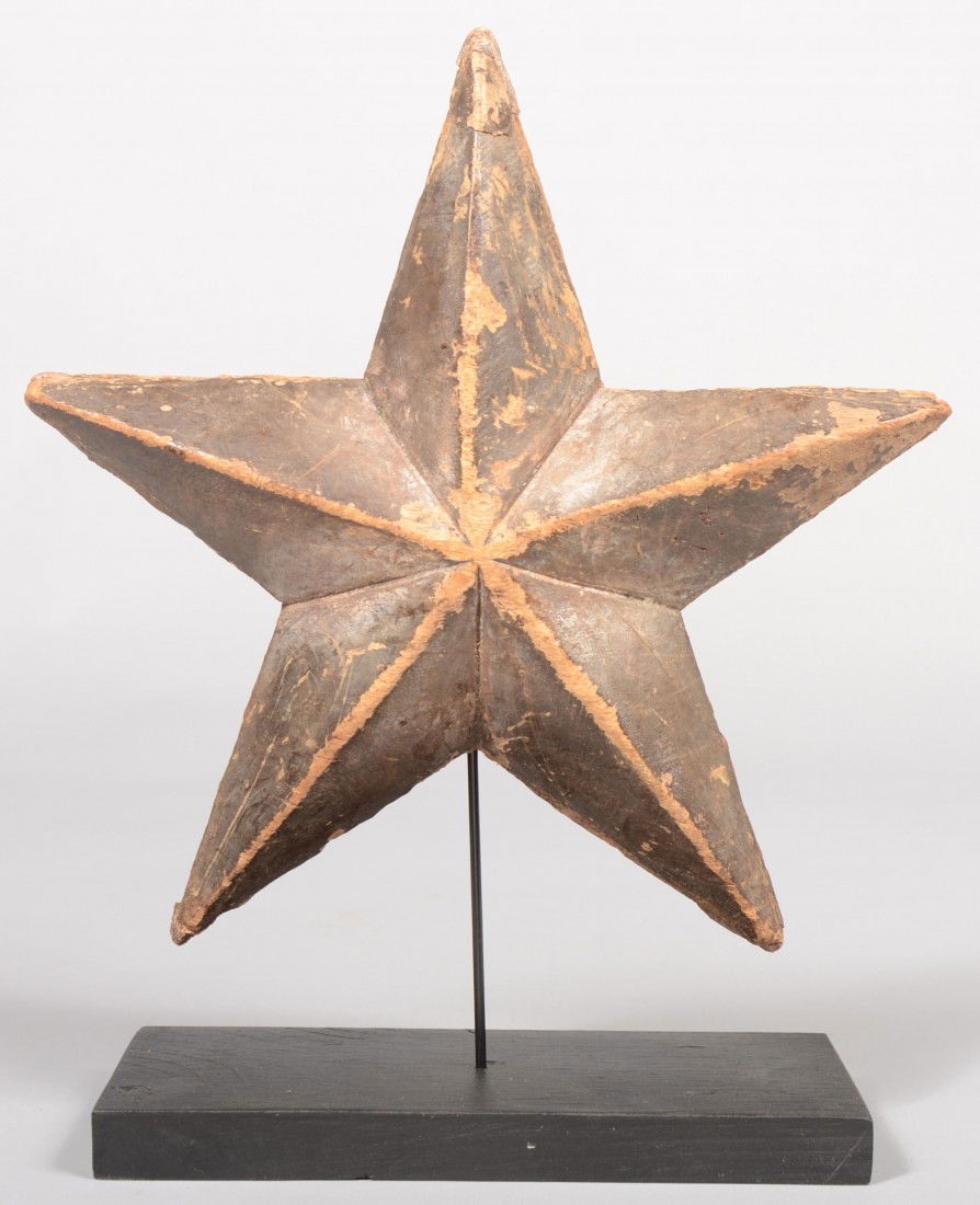 Carved and Painted Wood Five Point Star on Base. P: Carved and Painted Wood Five Point Star on Base. Painted dull green the carving is mounted on a wire from a black wood base. 10"dia. Condition: Surface shows wear.