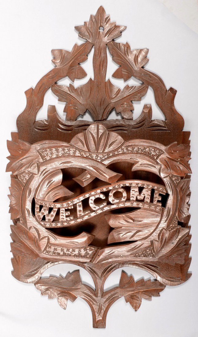 Carved and Pierced Walnut Wall Pocket. Foliate des: Carved and Pierced Walnut Wall Pocket. Foliate designs with "WELCOME" bannered across the front. An impressed '51' on back. 24"h. X 13 1/2"w. Condition: Good.