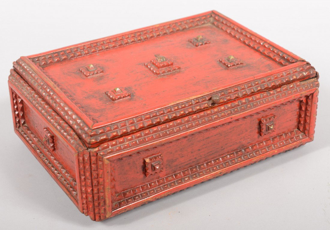 Red Painted Tramp Art Sewing Box. Layered chip car: Red Painted Tramp Art Sewing Box. Layered chip carved strips frame recessed box panels with layered square bosses topped with brass tacks. Same for feet. Hinged lid reveals floral printed cotton fabri