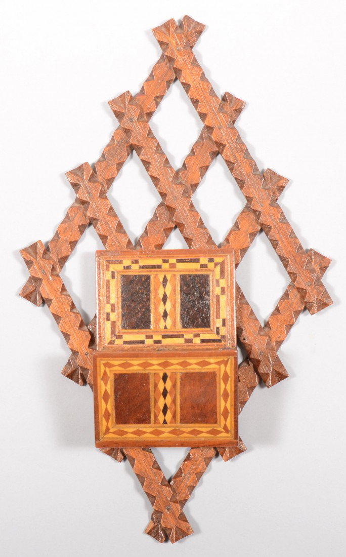 Wall Mounted Tramp Art Match Safe. Backing made up: Wall Mounted Tramp Art Match Safe. Backing made up of chip carved grid in a diamond shape. Applied divided match pocket made of parquet pieces of multi-colored wood pieces. Unmarked. 11 3/4"h. X 7"w. 