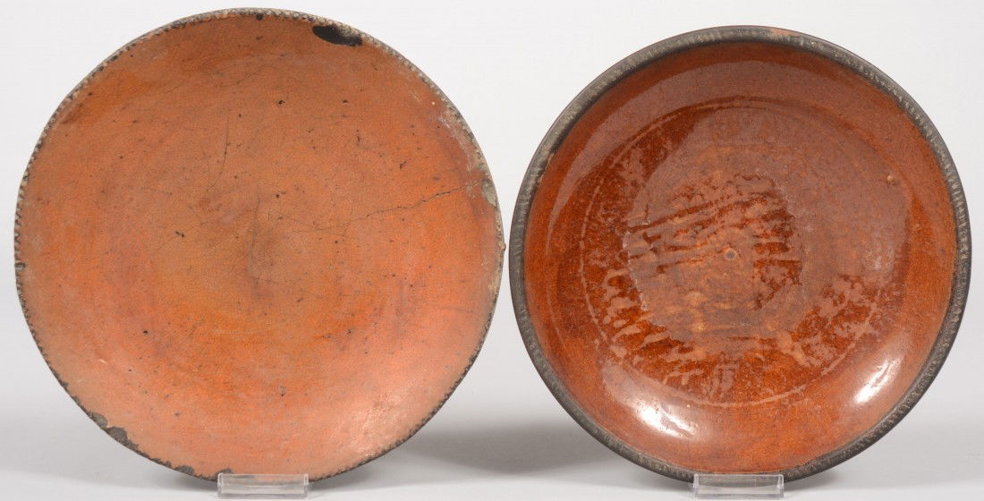 Two Plain Redware Dishes. No makers marks. Both wit: Two Plain Redware Dishes. No makers marks. Both with coggle rims. Other 10 1/4"dia. Condition: One good. Other has a crack from rim and several chips off around rim.