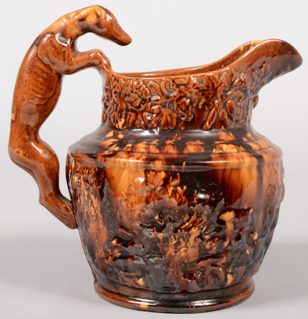 Rockingham Glazed Hound Handled Pitcher. Marked on : Rockingham Glazed Hound Handled Pitcher. Marked on bottom: "Harker, Taylor & Co., East Liverpool, O(hio)." This company produced from 1847 to 1851. Spout collar decorated with bas relief of grapes and