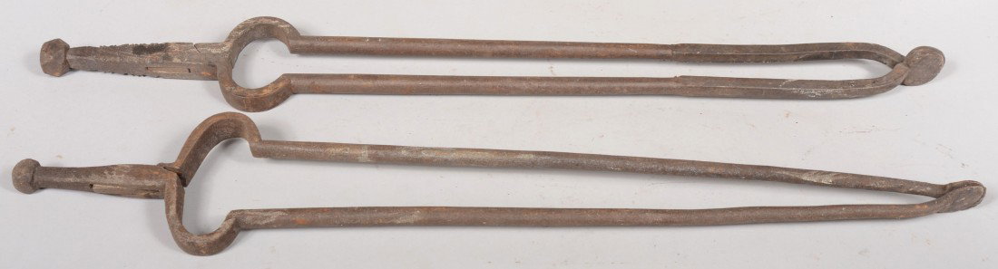 Two Similar Wrought Iron Fireplace Tongs. Both wit: Two Similar Wrought Iron Fireplace Tongs. Both with faceted finials. Unmarked. 28"l. and 29 1/2"l. Condition: Good with use wear.
