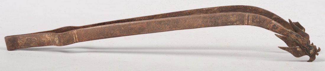 Wrought Iron Ember Tongs. Curved tweezer type with: Wrought Iron Ember Tongs. Curved tweezer type with copper and iron bird like cut tips. Unmarked. 21"l. Condition: One tip 'wing' broken.