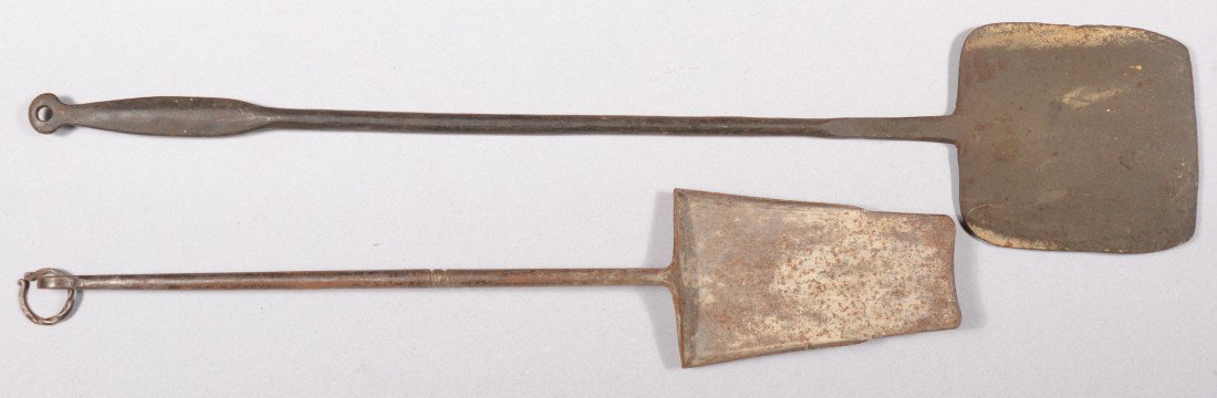 Two Wrought Iron Hearth Tools. An ash shovel with : Two Wrought Iron Hearth Tools. An ash shovel with loop finial and twisted hanging ring. 25"l. Along with a peel. Flat bladed handle and loop finial hanger, 32 1/2"l. Both unmarked. Condition: Good wit