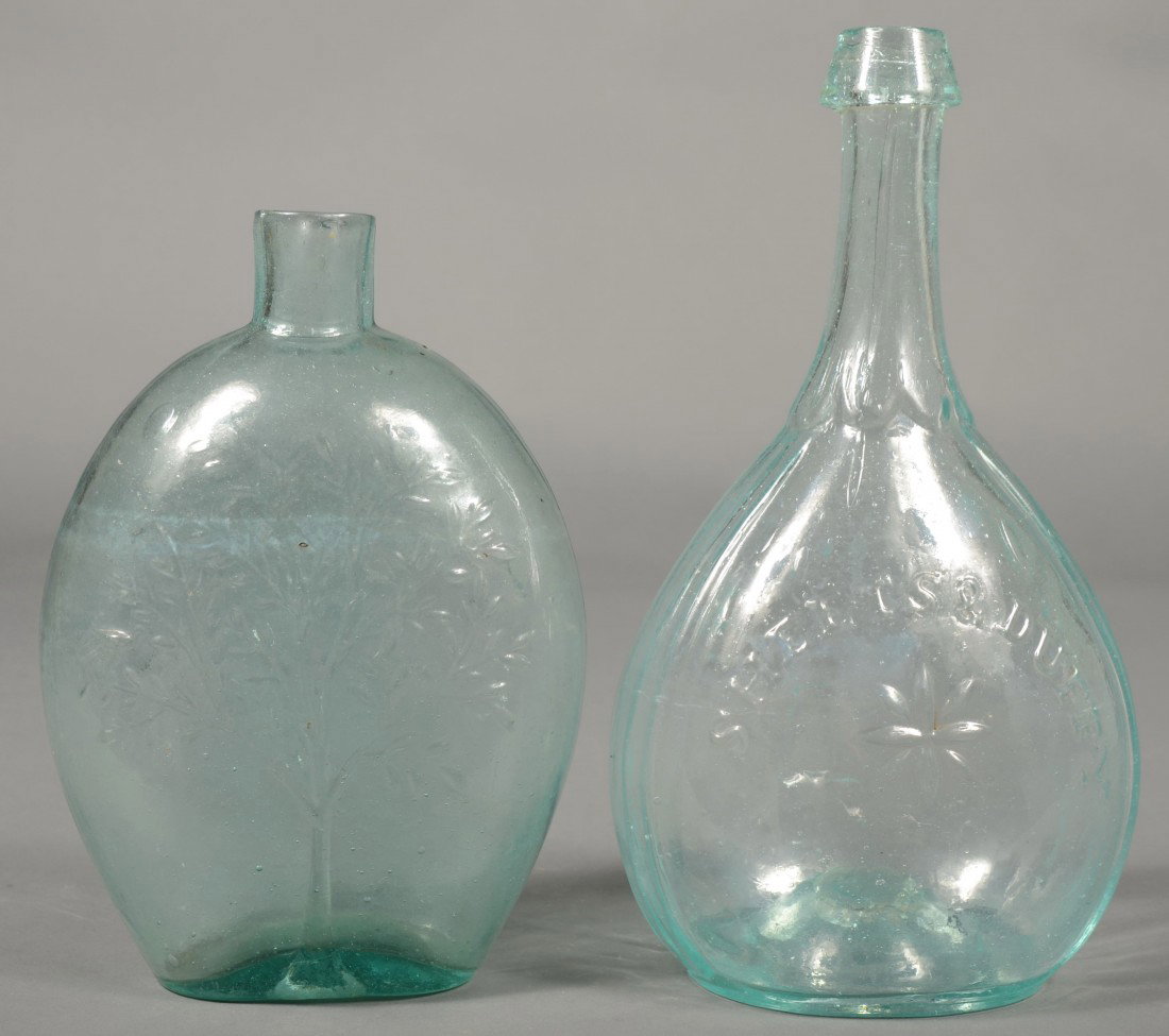 Two Aquamarine Blown Glass Quart Bottles; 1st is a: Two Aquamarine Blown Glass Quart Bottles; 1st is a quart size flask with double sided tree with foliage and buds, plain lip and pontil mark, (McKearin GX-18), 7 3/4" high, 2nd is a sheaf of wheat with