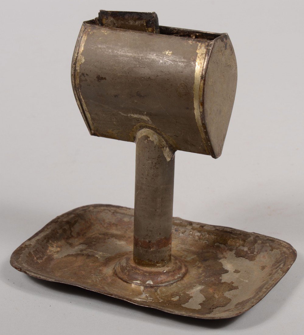 Tinned Sheet Iron Lard Lamp. A Kinnear patent ovoi: Tinned Sheet Iron Lard Lamp. A Kinnear patent ovoid shaped font with oil return groove containing a fill hole and wide wick holder. Mounted on a seamed round stem with rectangular tray. 6 1/2"h. Condi