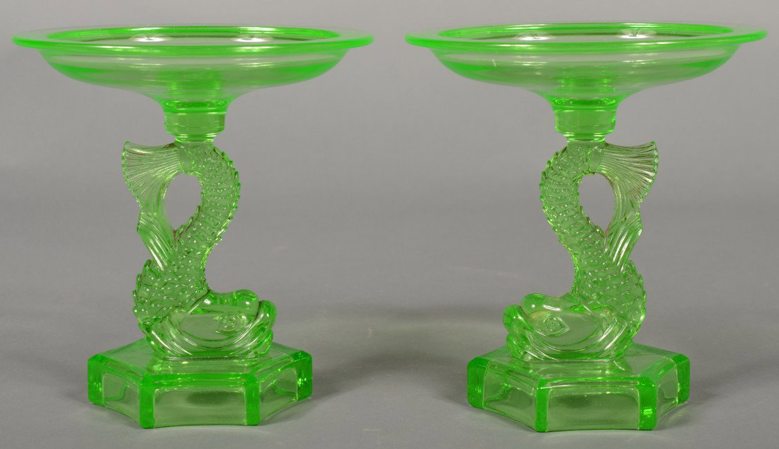 Pair of Green Pressed Glass Compotes. Full dimensi: Pair of Green Pressed Glass Compotes. Full dimensional dolphins on a hexagonal base supporting a round dish. Unmarked. 7 1/2"h. and 7"dia. Condition: Good without damage.