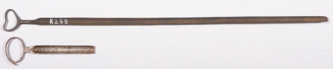 Two Wrought Iron Cheese Triers. Long one with hear: Two Wrought Iron Cheese Triers. Long one with heart shape ring handle, unmarked, 24"l. along with another with oval ring handle with a tack puller and marked: "R. Timmin & Sons" at hilt, 6 1/2"l. Cond