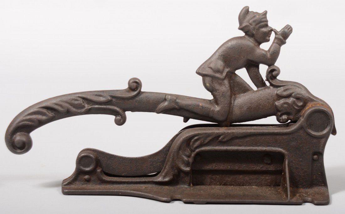 Cast Iron Figural Plug Tobacco Cutter. No makers m: Cast Iron Figural Plug Tobacco Cutter. No makers marks. Geared mechanism. Foliate handle with a boy thumbing his nose on top of lever. Base has screw down notches. 7 1/2"h. X 12 1/2"l. Condition: Good