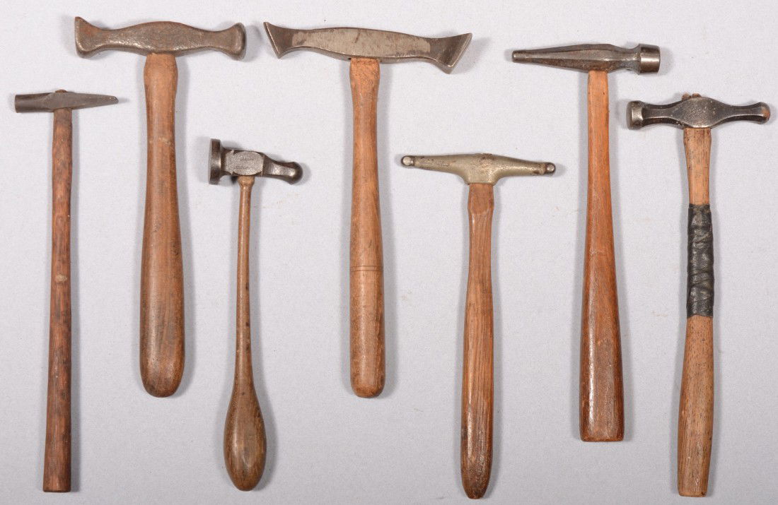 Group of Seven Peening Hammers. According to the c: Group of Seven Peening Hammers. According to the consignor these are silversmith hammers with different double faced heads. One is a small planishing hammer marked: "L. Huguenot - Tissot, France."