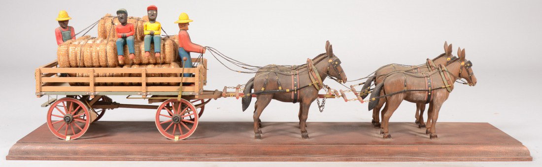 Contemporary Carved and Assembled Four Mule Team S: Contemporary Carved and Assembled Four Mule Team Stake Wagon with Cotton Bales. Also attached is: A white driver and three black workmen all mounted on a molded edge wood board. The board is signed un