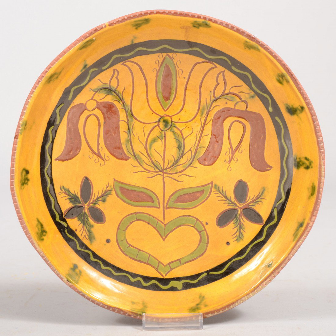 Three Color Slip and Scraffito Decorated Breininge: Three Color Slip and Scraffito Decorated Breininger Dish. Three tulip blooms with a heart and leaves in green, black border band with green serpentine accent on a yellow slip ground. Coggle rim with i