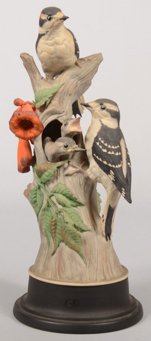 Boehm Limited Edition "Downy Woodpeckers" #427. Ma: Boehm Limited Edition "Downy Woodpeckers" #427. Male and female adult birds on a branch with orange and green trumpet vines and two chicks heads protruding from a hole in branch, with a black round ba