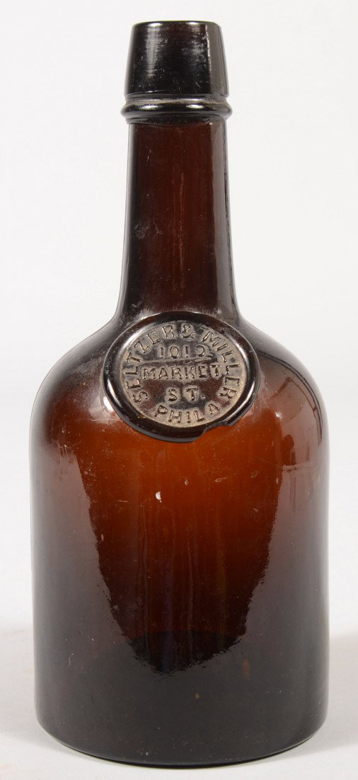 Seltzer & Miller Brown Glass Whiskey Bottle with M: Seltzer & Miller Brown Glass Whiskey Bottle with Medallion Label. Address also included: "1019 Market Street, Phila." Two part mold with applied tapered top for cork. 9 3/4"h. Condition: Good, no dama