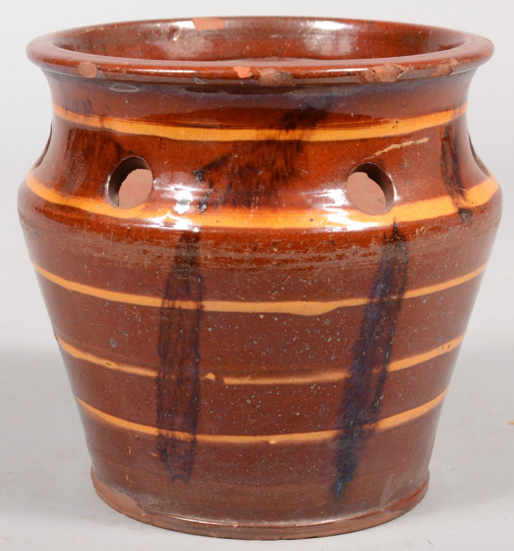Conical Redware Flower Pot. Tapered sides with a r: Conical Redware Flower Pot. Tapered sides with a reduced concave neck with holes and slightly rolled rim. Ringed with five yellow slip bands and vertical manganese brush strokes. Glaze does not extend