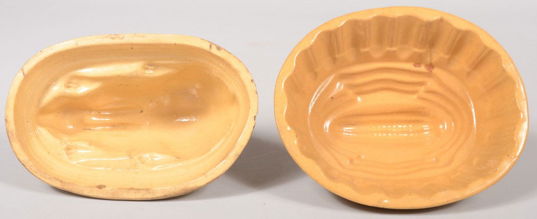 Two Yellowware Food Molds. A rabbit on oval base a: Two Yellowware Food Molds. A rabbit on oval base and a gadrooned and stepped loaf with an ear of corn on top. Corn: 7 7/8"l. and rabbit: 8"l. Condition: Corn two small chips off base rim. Rabbit has t