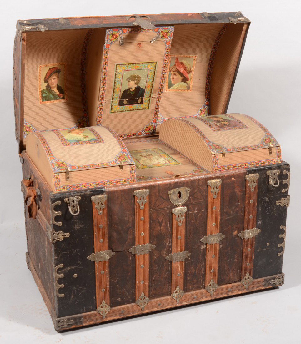 Late 19th Century Leather Covered Camel-back Steam: Late 19th Century Leather Covered Camel-back Steamer Trunk with oak battens and cast iron mountings. Fitted interior with paper lining and original lithographs of well-dressed ladies in Victorian atti