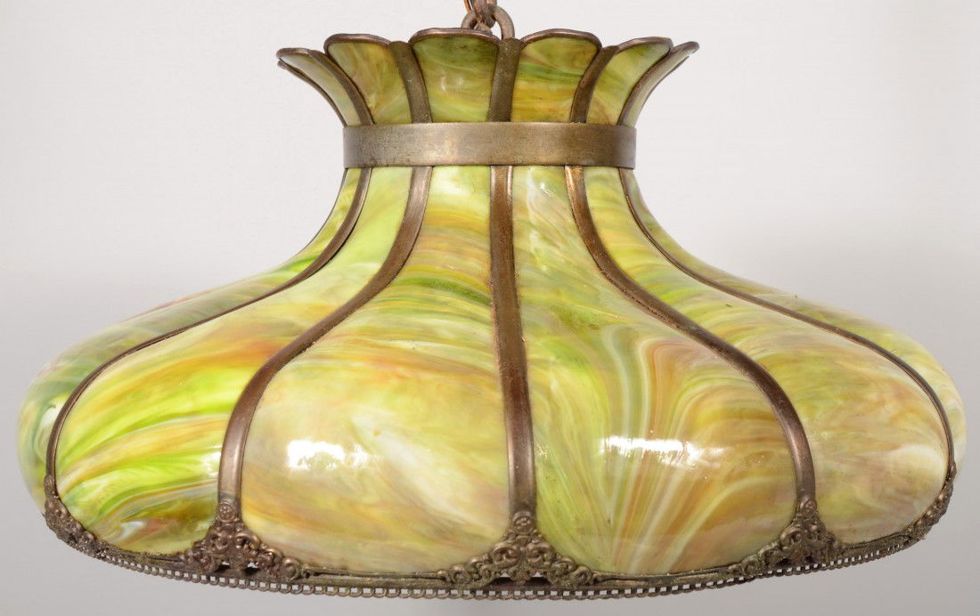 Hanging Sectional Slag Glass Lamp Shade. Green wit: Hanging Sectional Slag Glass Lamp Shade. Green with swirled colors in an onion shape with brass divider strips, brass chain link border and flared top. Wired for electric use with ceiling cap, chain a