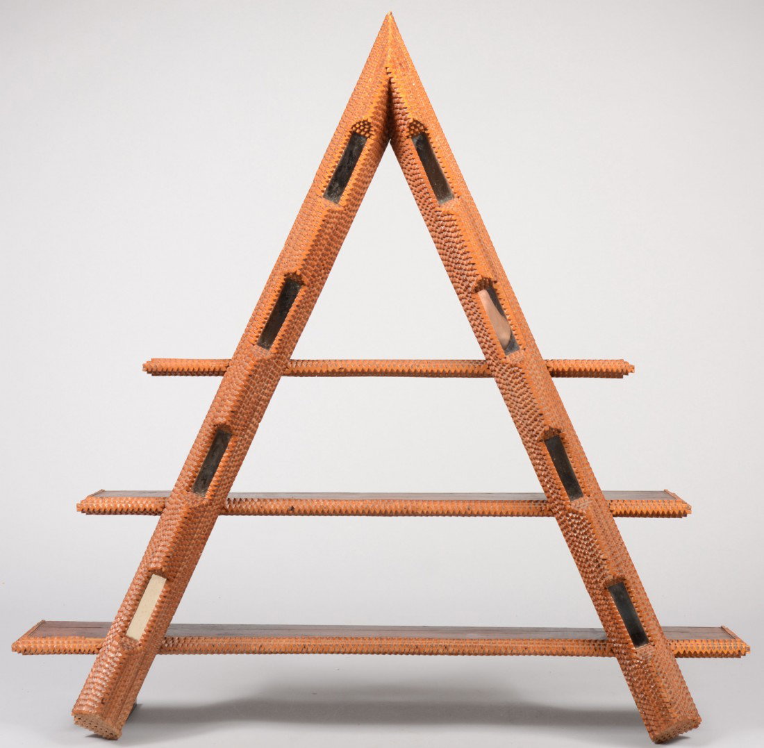Chip Carved Tramp Art Triangular Wall Shelf. Three: Chip Carved Tramp Art Triangular Wall Shelf. Three dark stained wood shelves joined to intersecting diagonal supports. Edges of all covered with layers of chip carved light colored wood and sections o