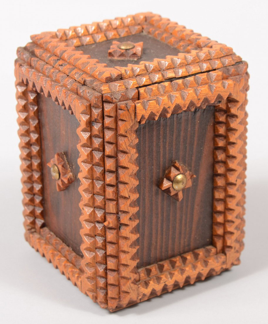 A Small Hand Made Trick Coin Bank. Tramp Art box t: A Small Hand Made Trick Coin Bank. Tramp Art box type with light chip carved and layered wood strips around dark recessed panels each with a small square rosette and brass tack. Small drawer at top ha