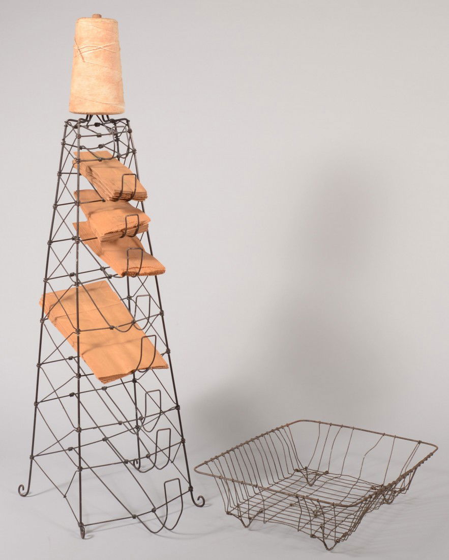 Two Wire Racks. A pyramid shaped bag stand with ni: Two Wire Racks. A pyramid shaped bag stand with nine graduated holders for paper bags. Scrolled feet and a hanger loop at top. 33"h. Along with a rectangular multi-purpose rack with five feet. 16 1/2"
