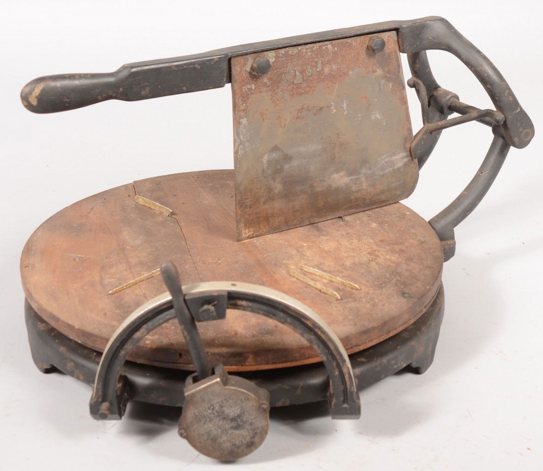 Full Wheel Mechanical Cast Iron Cheese Cutter. Lab: Full Wheel Mechanical Cast Iron Cheese Cutter. Labeled: "Computing Cheese Cutter Co., Anderson, Ind., Patd. Dated Sept. 1905." A rotating wood platform calibrated by an adjustable lever on the side an
