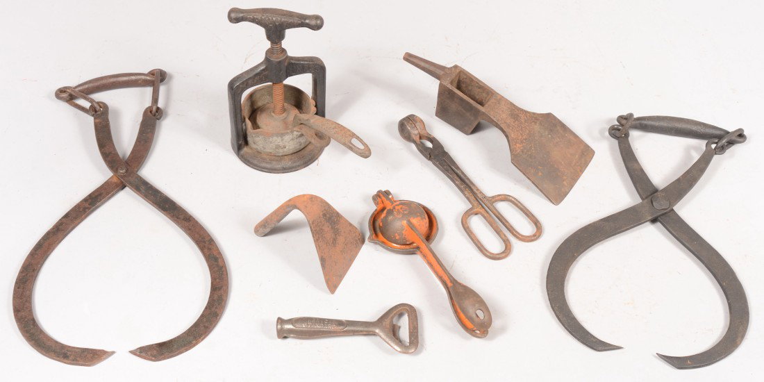 Group of Cast and Wrought Iron Tools. A "Brighton: Group of Cast and Wrought Iron Tools. A "Brighton Meat Press", 8"h.; a "Tonawanda Pig Iron" bottle opener, 5 3/4"l.; a hand dough scrapper, 4 1/2"l.; a framing adz head with pin poll marked: "L. & I.J
