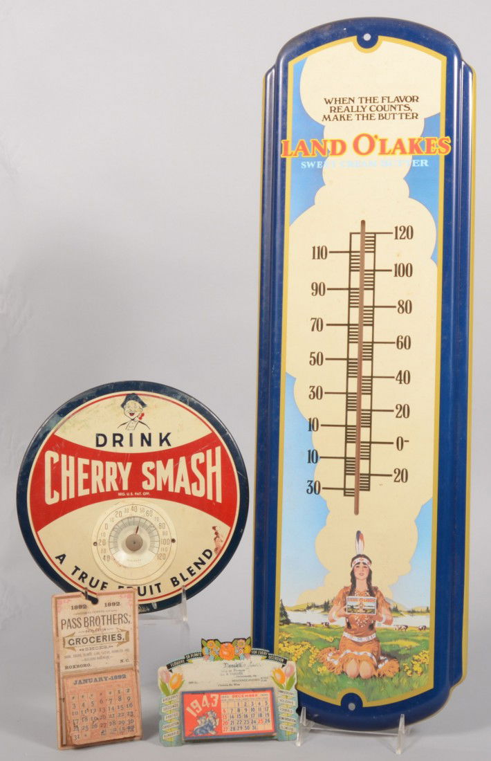 Four Piece Mixed Advertising Group. Including: A p: Four Piece Mixed Advertising Group. Including: A printed metal Land O' Lakes thermometer, 27"l.; a printed metal Cherry Smash circular thermometer, 9"dia.; an unused printed metal desk calendar for Vi