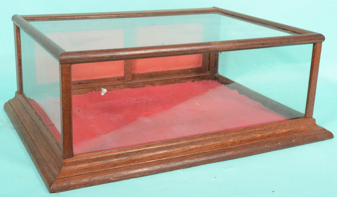 Horizontal Countertop Golden Oak and Glass Display: Horizontal Countertop Golden Oak and Glass Display Case. No label. Three glass sides and top with double paneled sliding rear doors and molded base. 13"h. X 36"w. X 26 1/4"d.