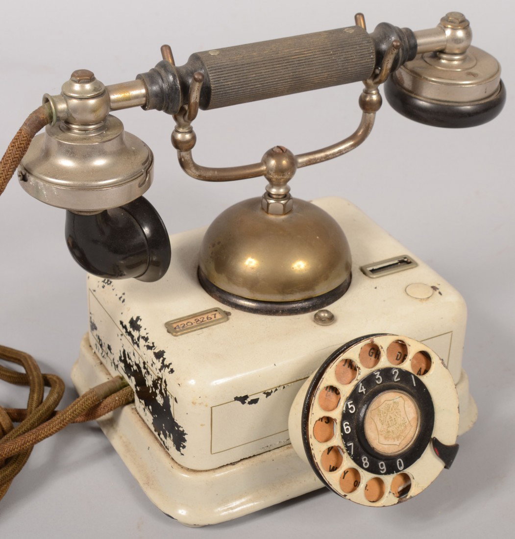 European Style Telephone Set. Black metal case pai: European Style Telephone Set. Black metal case painted white, rotary dial and top mounted bell with hand set cradle. Set has Gutta Percha mouth and ear pieces and grip on a plated frame. Knit fabric c