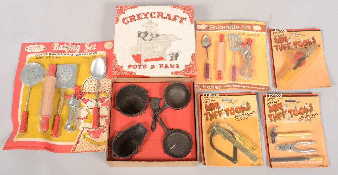 Group of New Old Stock Toys. Five blister packs of: Group of New Old Stock Toys. Five blister packs of tools. Three packs of mechanics and two packs of baking. Also a four piece boxed cast iron cookware set for a toy cook stove. Labeled: "Greycraft Pot