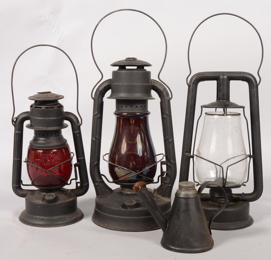 Four Lighting Devices. Three Dietz Kerosene Lanter: Four Lighting Devices. Three Dietz Kerosene Lanterns. A clear globe Hy-Lo, 13 1/2"h. w/o bail; a red globe Little Wizard, 11 1/2"h. w/o bail; a Blizzard, 14 1/2"h. w/o bail and a smudge pot lighter wi