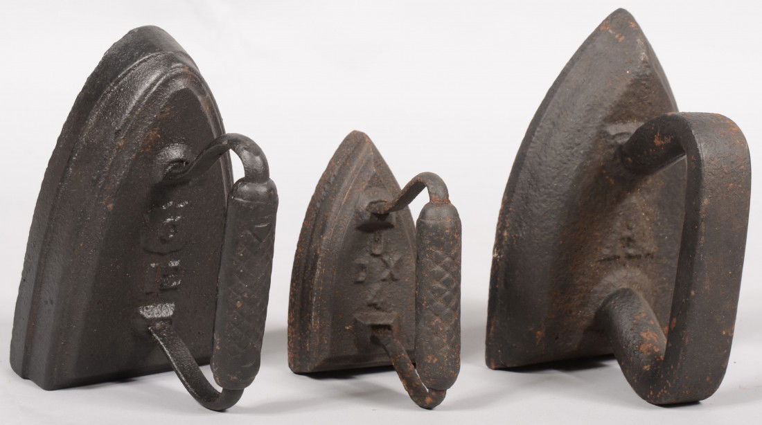 Three Solid Cast Iron Sad Irons. Wedge shaped with: Three Solid Cast Iron Sad Irons. Wedge shaped with cast in handles. Marked: A, 7 3/4"l.; C-12, 7 1/2"l.; and UDX-4, 5"l.