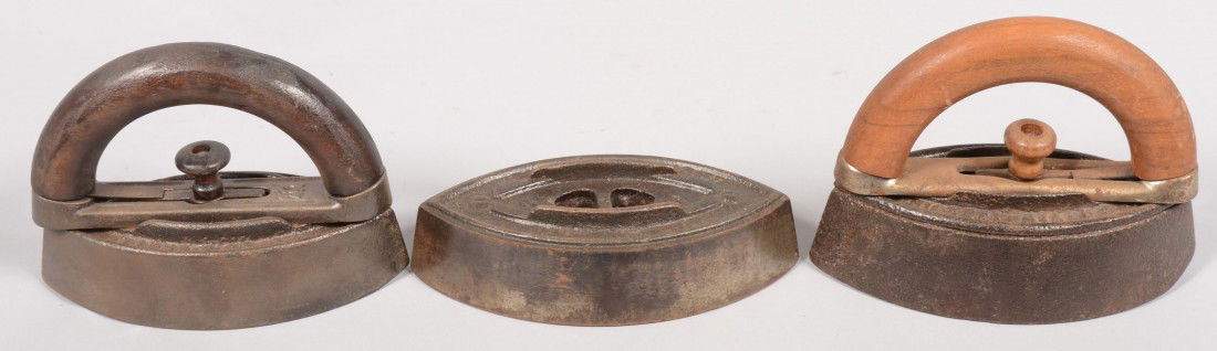 Three Cast Clothing Irons. Three boat shaped bases: Three Cast Clothing Irons. Three boat shaped bases with two interchangeable wood and iron frame handles. Marked: "Bless & Drake, Newark, N.J." All 6"l., with handles 6"h.
