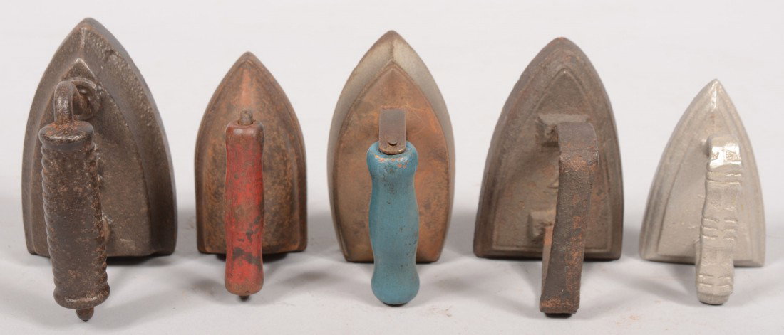 Five Small Cast Sad Irons. None marked, but maybe: Five Small Cast Sad Irons. None marked, but maybe children's. Two one piece cast irons, 4"l. & 3 5/8"l.; two with pressed steel covers and painted, blue and red, wood handles: 3 3/4"l. & 3 3/8"l.; a s