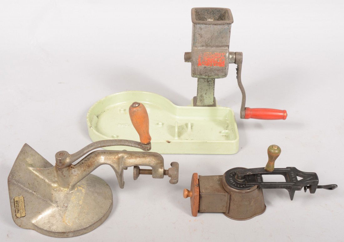 Three Cast Iron Graters. A drum grater with tinned: Three Cast Iron Graters. A drum grater with tinned sheet metal housing with wood knob crank. Made by "Lorraine Metal Mfg. Co., N.Y." 9"h.; a plated ice chipper with red handled wood crank attached to