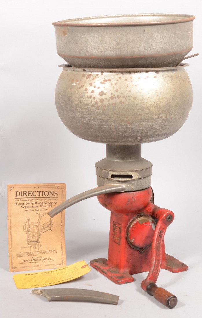 "Economy King Cream Seperator, No. 24." Red painte: Economy King Cream Seperator, No. 24. Red painted base with crank. Plated steel supply tank and screened funnel with appliances and directions booklet. 24"h. X 12"dia.