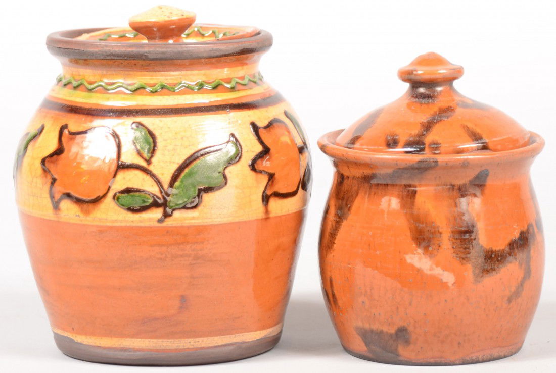 Two Small Turtle Creek Slip Decorated Redware Lidd: Two Small Turtle Creek Slip Decorated Redware Lidded Jars. Ovoid jar with four tulips on a slip band at shoulder and a concave knobbed lid. 5 1/4"h. X 4 1/2"dia. Along with a smaller manganese drip de