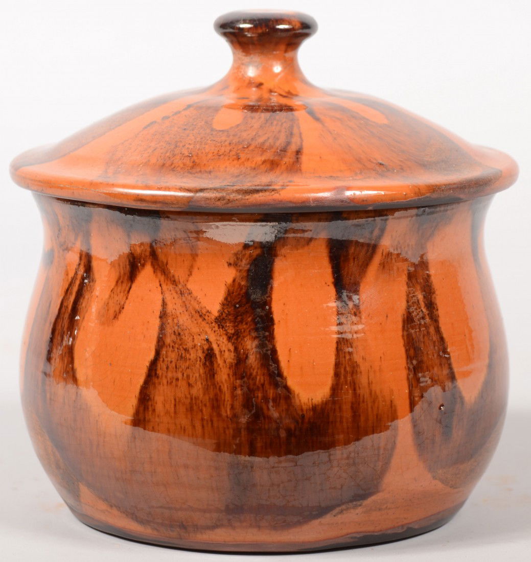 Turtle Creek Redware Jar. Manganese slip decoratio: Turtle Creek Redware Jar. Manganese slip decoration on hipped lid with knob and bulbous body. 6 1/2"h. X 6 1/4"dia.