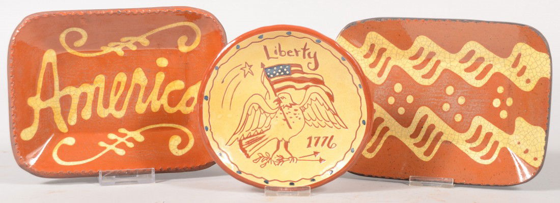 Three Small Contemporary Redware Dishes. Two recta: Three Small Contemporary Redware Dishes. Two rectangular and dished trays with coggle edges, and slip decoration. One bears "America" the other squiggle lines with dots. Both marked for Turtle Creek P